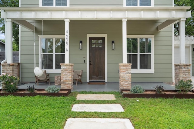 4605 Englewood Dr Unit A, Austin, TX 78745 - doorway to property featuring a porch and a lawn