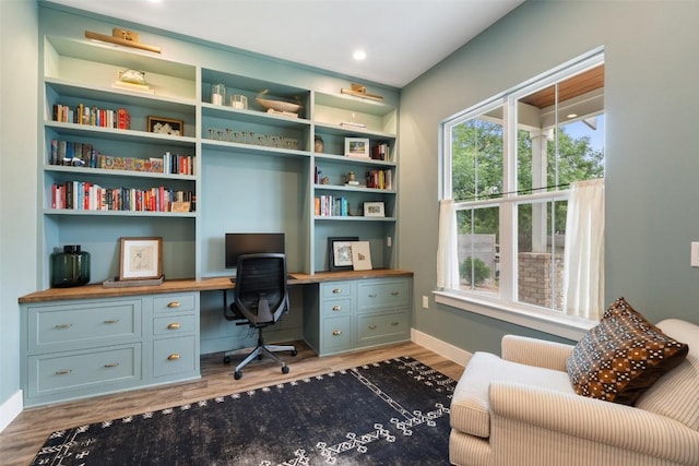 4605 Englewood Dr Unit A, Austin, TX 78745 - home office with built in desk, wood finished floors, and plenty of natural light