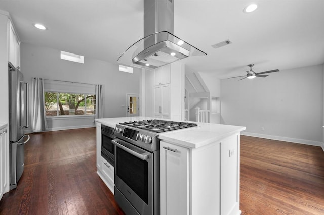 2109 W 10th St, Austin, TX 78703 - kitchen with stainless steel appliances, island exhaust hood, white cabinets, a center island, and recessed lighting