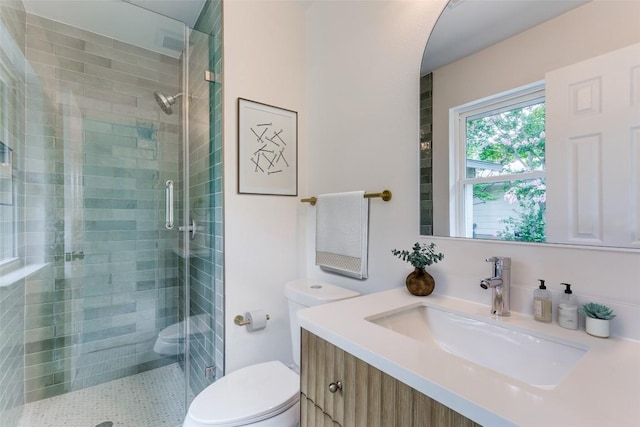 8409 Kimble Cv, Austin, TX 78757 - bathroom featuring toilet, vanity, and a shower stall