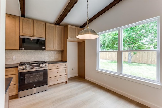 8409 Kimble Cv, Austin, TX 78757 - kitchen with appliances with stainless steel finishes, dark countertops, backsplash, baseboards, and decorative light fixtures