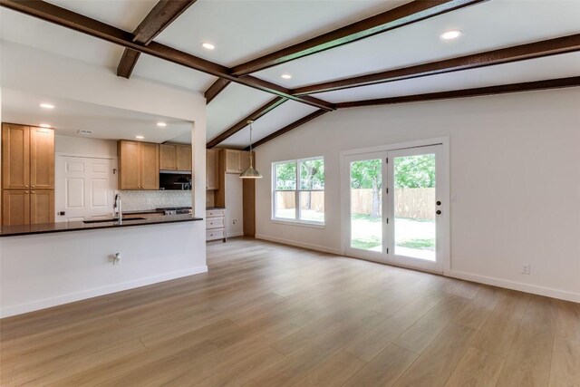 8409 Kimble Cv, Austin, TX 78757 - unfurnished living room featuring a sink, baseboards, light wood-style floors, and recessed lighting