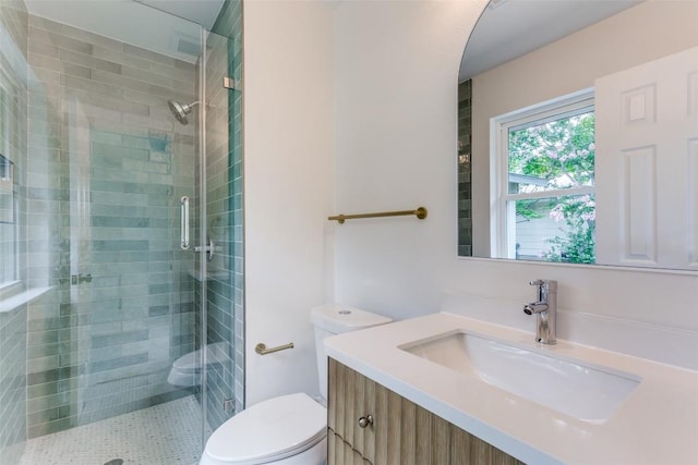 8409 Kimble Cv, Austin, TX 78757 - bathroom featuring toilet, a shower stall, and vanity
