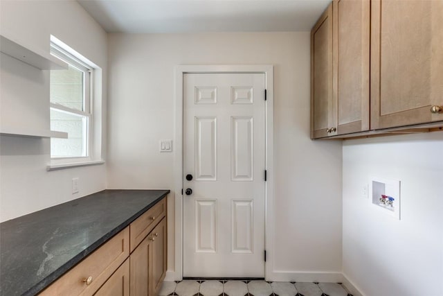 8409 Kimble Cv, Austin, TX 78757 - laundry area featuring washer hookup, cabinet space, and baseboards