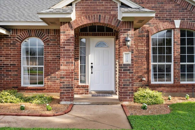 1509 Foster Dr, Cedar Park, TX 78613 - view of exterior entry with roof with shingles and brick siding