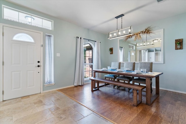 1509 Foster Dr, Cedar Park, TX 78613 - dining area featuring baseboards, a chandelier, and stone tile floors