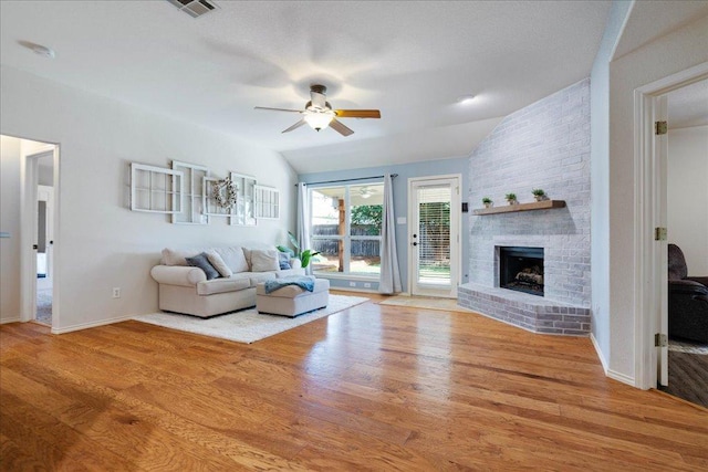 1509 Foster Dr, Cedar Park, TX 78613 - living area featuring a ceiling fan, wood finished floors, a fireplace, and baseboards