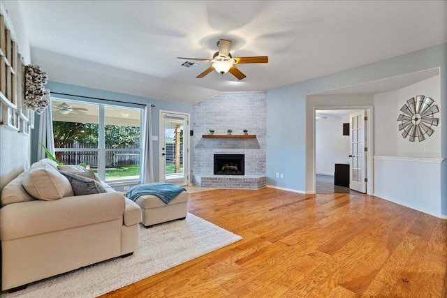1509 Foster Dr, Cedar Park, TX 78613 - living area featuring a ceiling fan, light wood-style floors, lofted ceiling, a fireplace, and baseboards