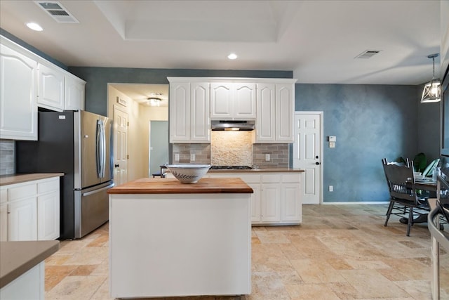 1509 Foster Dr, Cedar Park, TX 78613 - kitchen featuring under cabinet range hood, wood counters, white cabinets, backsplash, and recessed lighting