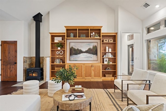 321 Hannah Dr, Dripping Springs, TX 78620 - living room with a wood stove, dark wood-style flooring, and high vaulted ceiling