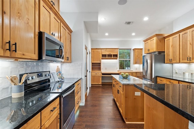 321 Hannah Dr, Dripping Springs, TX 78620 - kitchen with stainless steel appliances, dark wood-style floors, backsplash, dark stone counters, and recessed lighting