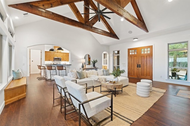 321 Hannah Dr, Dripping Springs, TX 78620 - living area featuring high vaulted ceiling, arched walkways, beam ceiling, baseboards, and dark wood-style floors