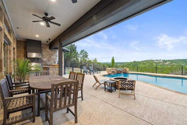 321 Hannah Dr, Dripping Springs, TX 78620 - view of patio / terrace with an outdoor fire pit, outdoor dining space, ceiling fan, an outdoor kitchen, and a pool with connected hot tub