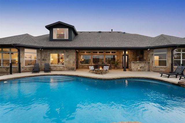 321 Hannah Dr, Dripping Springs, TX 78620 - pool at dusk with a patio area and an outdoor pool