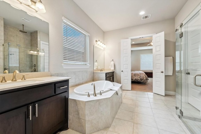 1005 Hezekiah Ln, Leander, TX 78641 - full bath with a shower stall, vanity, a bath, tile patterned floors, and a ceiling fan