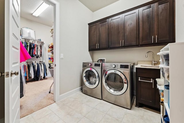 1005 Hezekiah Ln, Leander, TX 78641 - laundry area featuring cabinet space, washing machine and dryer, and light colored carpet