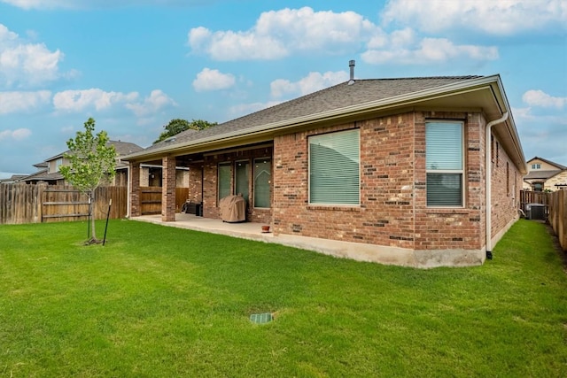 1005 Hezekiah Ln, Leander, TX 78641 - back of house featuring brick siding, a fenced backyard, and a patio