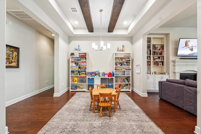 1005 Hezekiah Ln, Leander, TX 78641 - dining space with dark wood-type flooring, a chandelier, a fireplace, built in features, and recessed lighting