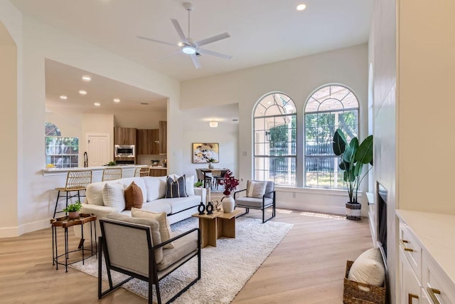 9124 Fainwood Ln, Austin, TX 78749 - living room featuring plenty of natural light, a ceiling fan, light wood-style floors, recessed lighting, and baseboards