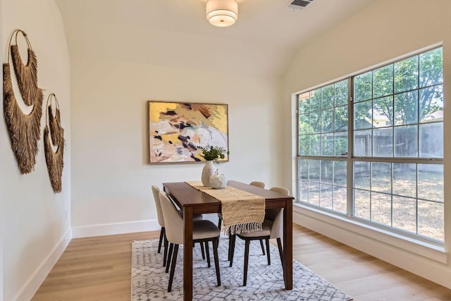 9124 Fainwood Ln, Austin, TX 78749 - dining area with light wood-type flooring, baseboards, and lofted ceiling
