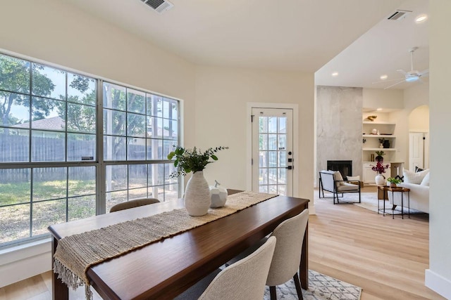 9124 Fainwood Ln, Austin, TX 78749 - dining area featuring plenty of natural light, arched walkways, a ceiling fan, light wood-type flooring, and recessed lighting