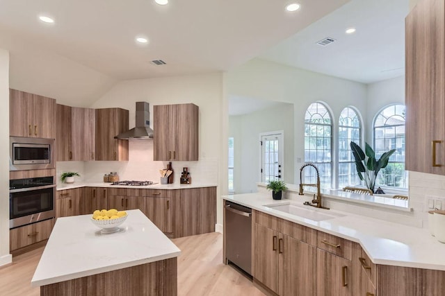 9124 Fainwood Ln, Austin, TX 78749 - kitchen with stainless steel appliances, wall chimney exhaust hood, modern cabinets, a sink, and recessed lighting