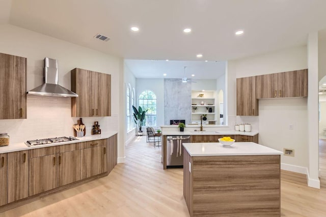 9124 Fainwood Ln, Austin, TX 78749 - kitchen with stainless steel appliances, wall chimney exhaust hood, brown cabinetry, modern cabinets, and decorative backsplash