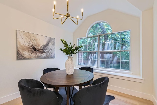 9124 Fainwood Ln, Austin, TX 78749 - dining area with a chandelier, lofted ceiling, baseboards, and light wood-type flooring