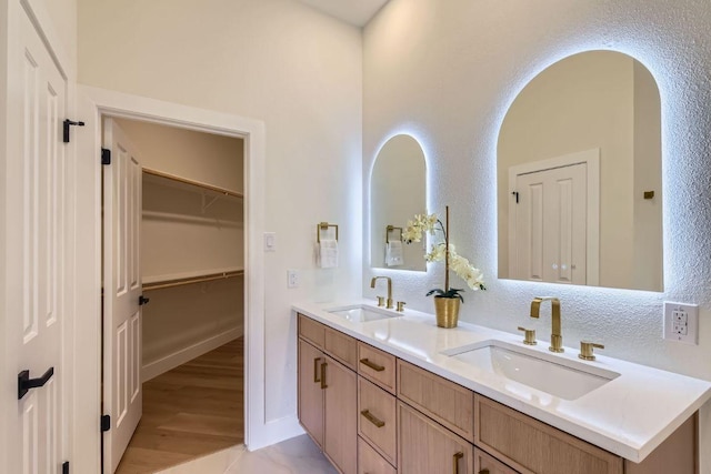 9124 Fainwood Ln, Austin, TX 78749 - full bathroom with double vanity and wood finished floors