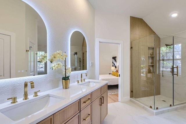 9124 Fainwood Ln, Austin, TX 78749 - full bathroom with ensuite bathroom, vaulted ceiling, double vanity, and a shower stall