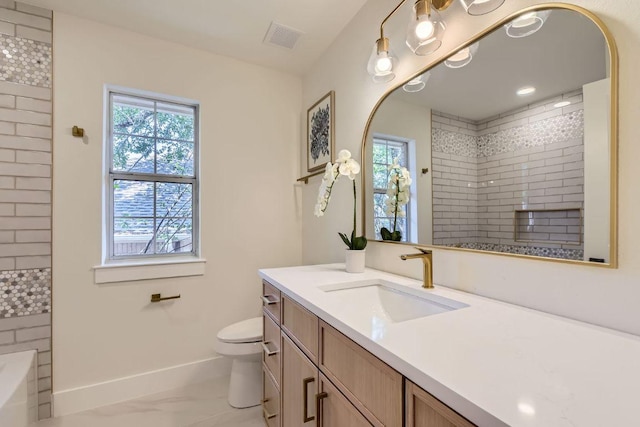 9124 Fainwood Ln, Austin, TX 78749 - full bathroom with vanity, toilet, baseboards, a tub, and a tile shower