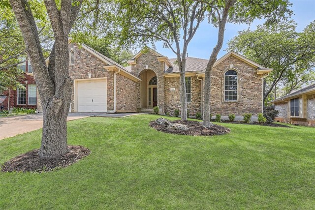 9124 Fainwood Ln, Austin, TX 78749 - view of front of property with a garage, driveway, a front yard, brick siding, and a shingled roof