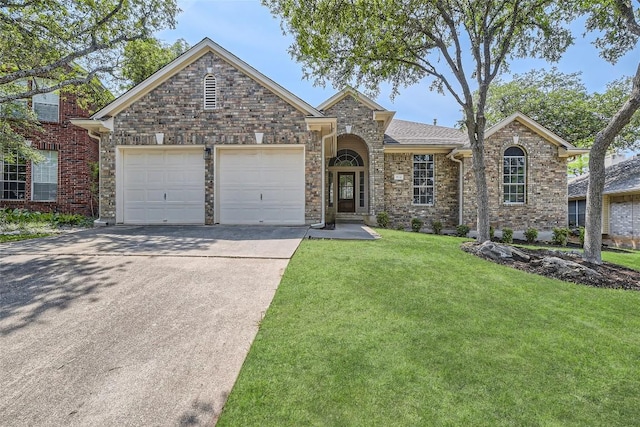 9124 Fainwood Ln, Austin, TX 78749 - traditional-style home with concrete driveway, an attached garage, a front yard, and stone siding