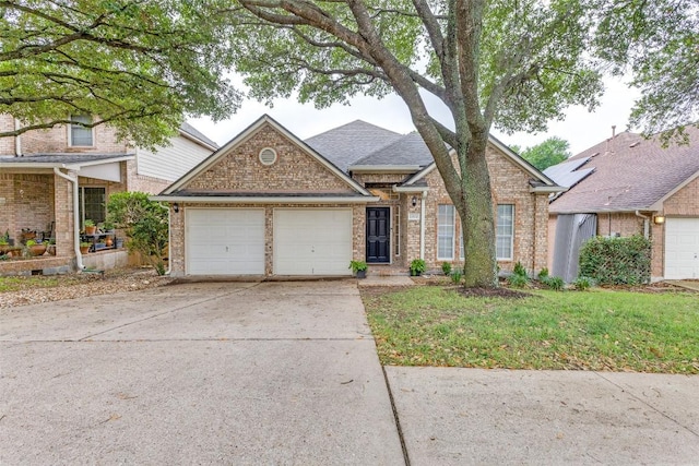 13532 Utah Flats Dr, Austin, TX 78727 - traditional-style home featuring brick siding, an attached garage, and concrete driveway