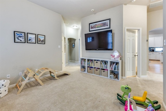 13532 Utah Flats Dr, Austin, TX 78727 - playroom with arched walkways, carpet flooring, and baseboards