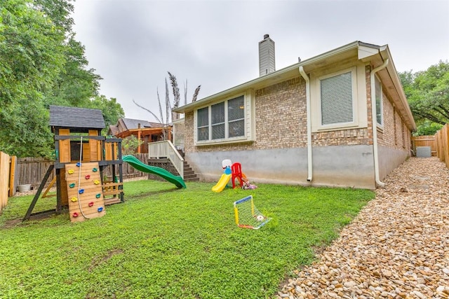 13532 Utah Flats Dr, Austin, TX 78727 - rear view of property featuring a playground, a chimney, central AC, and brick siding
