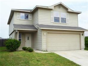 1516 Anise Dr, Austin, TX 78741 - view of front of house with an attached garage, concrete driveway, and a front lawn