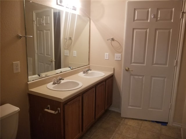 1516 Anise Dr, Austin, TX 78741 - bathroom featuring double vanity and toilet