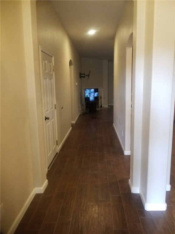 1516 Anise Dr, Austin, TX 78741 - corridor with arched walkways, baseboards, and dark wood-style flooring