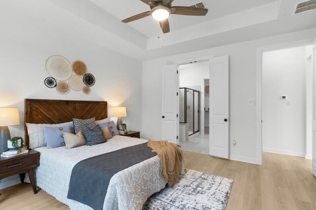 2705 Sage Ranch Dr Unit 2, Leander, TX 78641 - bedroom with light wood-type flooring, a tray ceiling, baseboards, and a ceiling fan