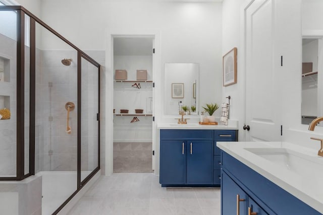 2705 Sage Ranch Dr Unit 2, Leander, TX 78641 - bathroom featuring a stall shower, a spacious closet, and two vanities