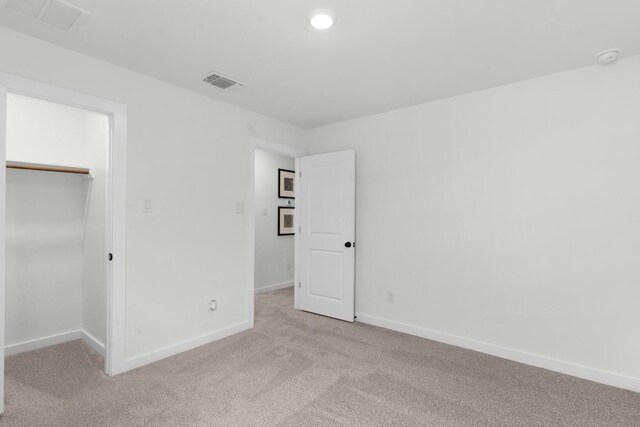 2705 Sage Ranch Dr Unit 2, Leander, TX 78641 - unfurnished bedroom with light carpet, baseboards, a spacious closet, and a closet