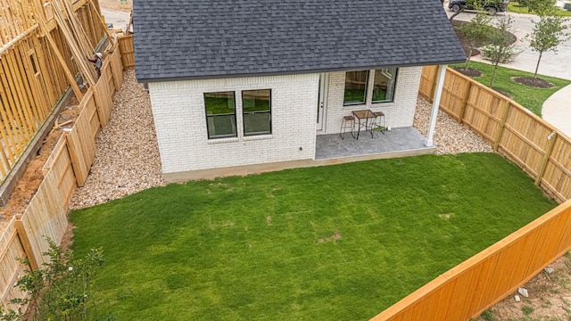 2705 Sage Ranch Dr Unit 2, Leander, TX 78641 - back of property with brick siding, roof with shingles, and a patio