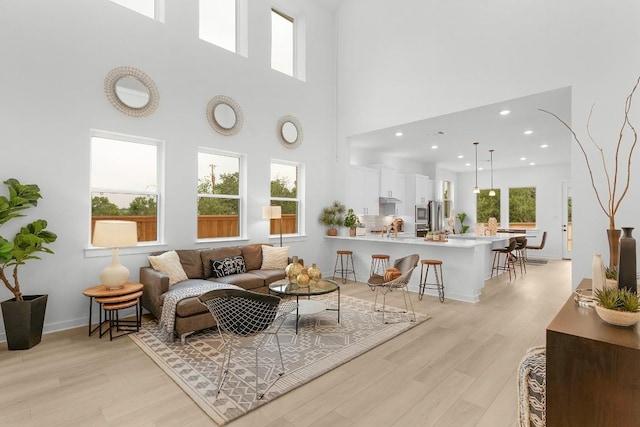 2705 Sage Ranch Dr Unit 2, Leander, TX 78641 - living room with light wood-type flooring, plenty of natural light, a high ceiling, and recessed lighting