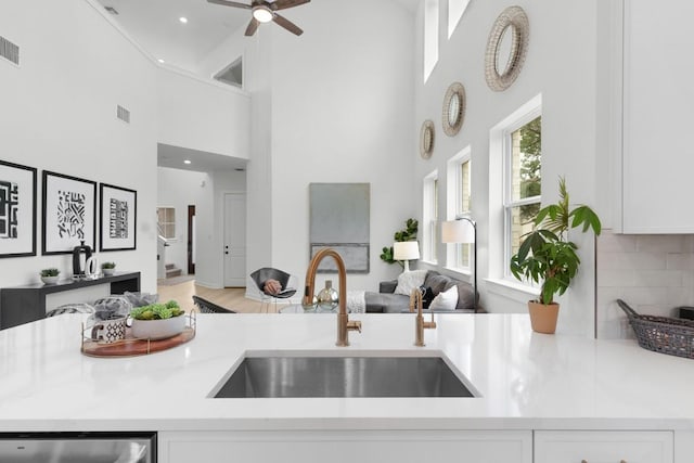 2705 Sage Ranch Dr Unit 2, Leander, TX 78641 - kitchen featuring a sink, a high ceiling, white cabinets, light countertops, and ceiling fan