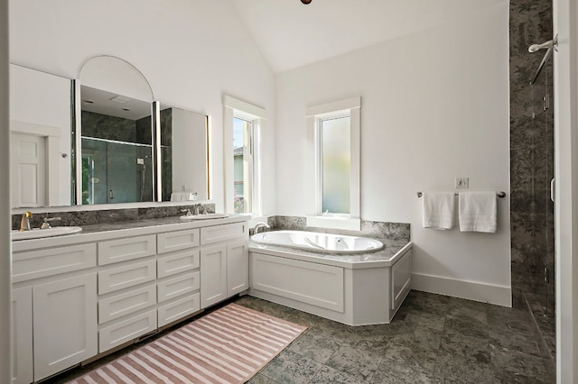 800 W Lynn St, Austin, TX 78703 - full bathroom featuring a stall shower, double vanity, a bath, vaulted ceiling, and baseboards