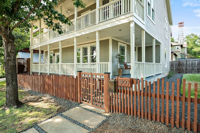 800 W Lynn St, Austin, TX 78703 - view of front of property with a porch, a balcony, ceiling fan, and a fenced front yard