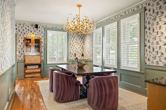 800 W Lynn St, Austin, TX 78703 - dining space featuring wallpapered walls, a chandelier, crown molding, light wood-style floors, and a wainscoted wall