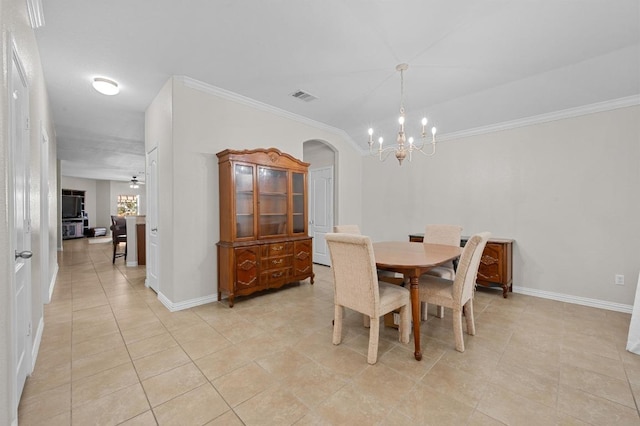 1286 Talley Loop, Buda, TX 78610 - dining room with a chandelier, light tile patterned floors, crown molding, baseboards, and arched walkways
