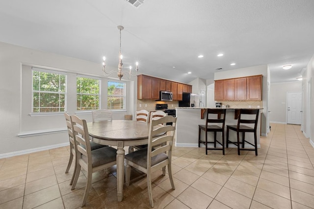 1286 Talley Loop, Buda, TX 78610 - dining space featuring a chandelier, light tile patterned floors, vaulted ceiling, baseboards, and recessed lighting